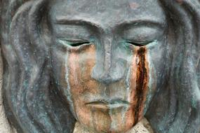 sad female face with traces of tears, Bronze sculpture