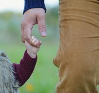 hand of father and daughter as a symbol of love