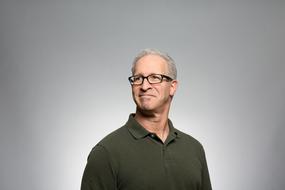 portrait of an adult gray-haired man with glasses