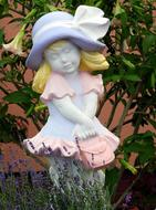 plaster figurine little girl in the garden