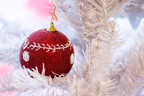 red christmas ball on white spruce