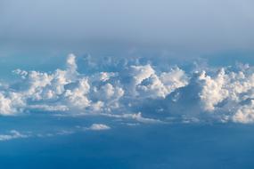 white cumulus clouds high in the sky