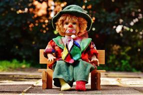 Sad Clown Doll sits on bench