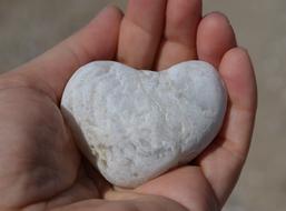 Heart shape pebble Stone on Hand