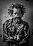 black and white photo of a homeless man with curly hair