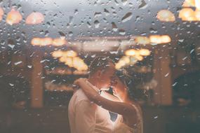 wedding couple through wet glass