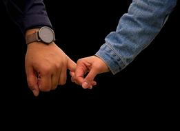 girl holds a loved one by the finger