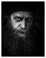 monochrome photo of a homeless man with a long beard