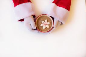 Santa Claus holding a cup of hot chocolate