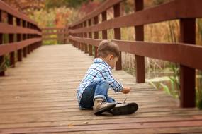 fishing boy on the wooden bridge