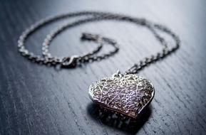 heart shaped pendant chain on a black table