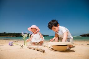 girl and boy playing on the beach