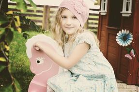 girl on a toy rocking horse