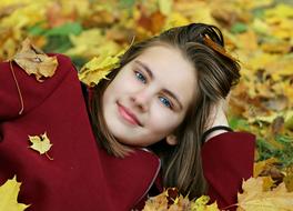 happy girl in autumn leaves