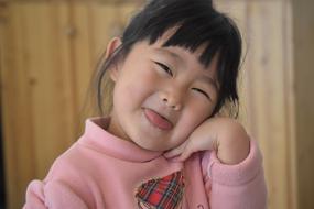 photo of an asian girl with her tongue hanging out