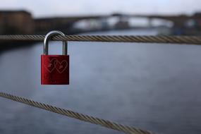 red Love lock on metal rope, uk, scotland, glasgow