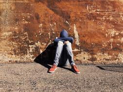 Sad Young person and old wall