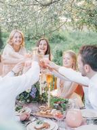 friends celebrate a holiday in the garden in summer