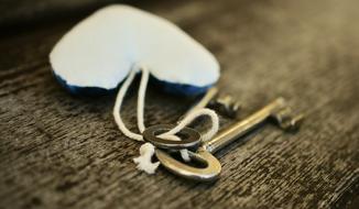 Key and beautiful Heart on the wooden surface