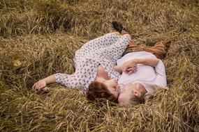 Love Couple, young man and woman laying on grass