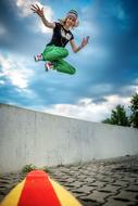 photo of a jumping girl on a skateboard