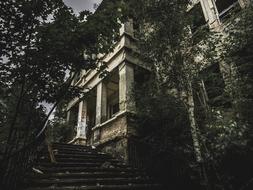 Abandoned building with steps at porch