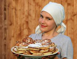 lot of pancakes on a large plate in hand