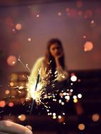 photo of sparklers and a girl on the couch