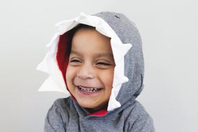 Child boy in grey hoodie Laughing