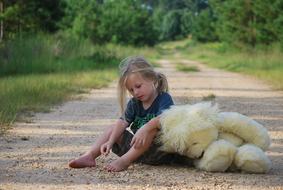 girl and plush toy on the road