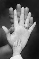 family hands with newborn hand