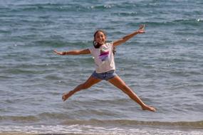 girl jumping on the beach