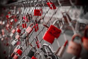 red locks of lovers on a metal grate