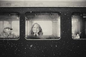 black and white photo of children in a train carriage