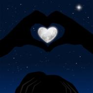 painted moon in the shape of a heart in the hands