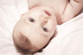 photo of a baby on a white pillow