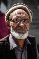 photo of an elderly man in a hat and glasses