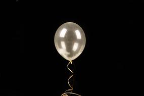 neon white balloon on a black background