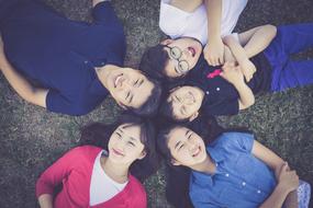 photo of happy asian children on grass