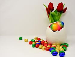 colorful Easter Eggs, tiny candies, and bouquet of tulips