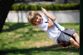 boy on a swing in the garden