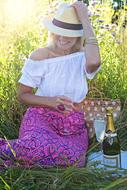 girl with champagne on a picnic