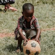 African kid playing football