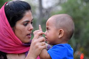 Cute Child boy on Motherâs hands