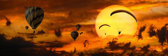 hot air balloons and paragliders at sunset sky, collage