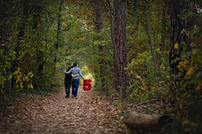 couple walking with the number five on a forest road