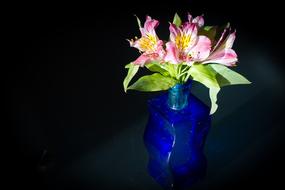 bouquet of pink lilies in a blue vase