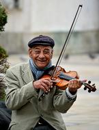 Smiling street musician with the violin