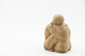 Hugging couple, wooden figurine at white background