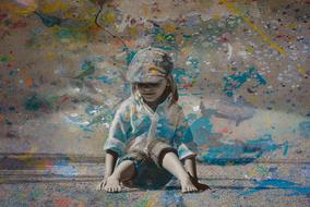 Child in blue Paint sits on Ground